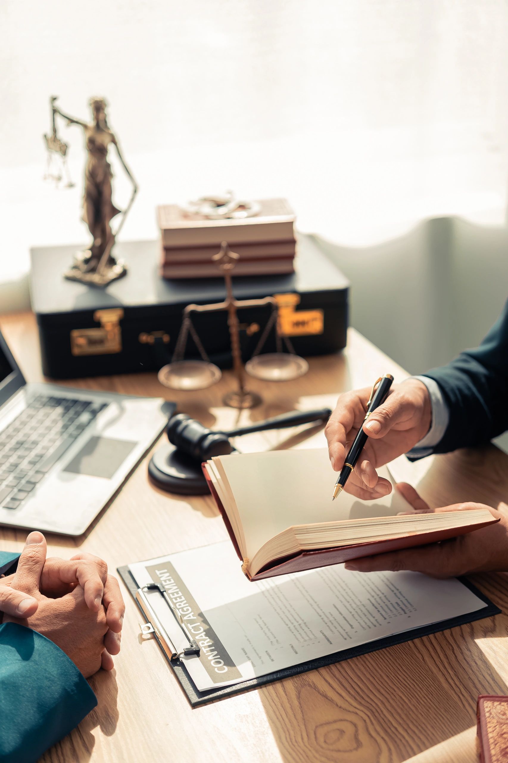 Two professionals discussing notes in an office setting.